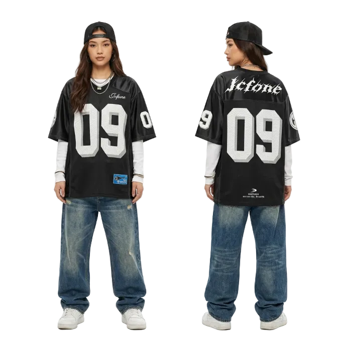 Front and back view of a model in an oversized black 09 graphic jersey and baggy vintage denim jeans for a Y2K streetwear look.