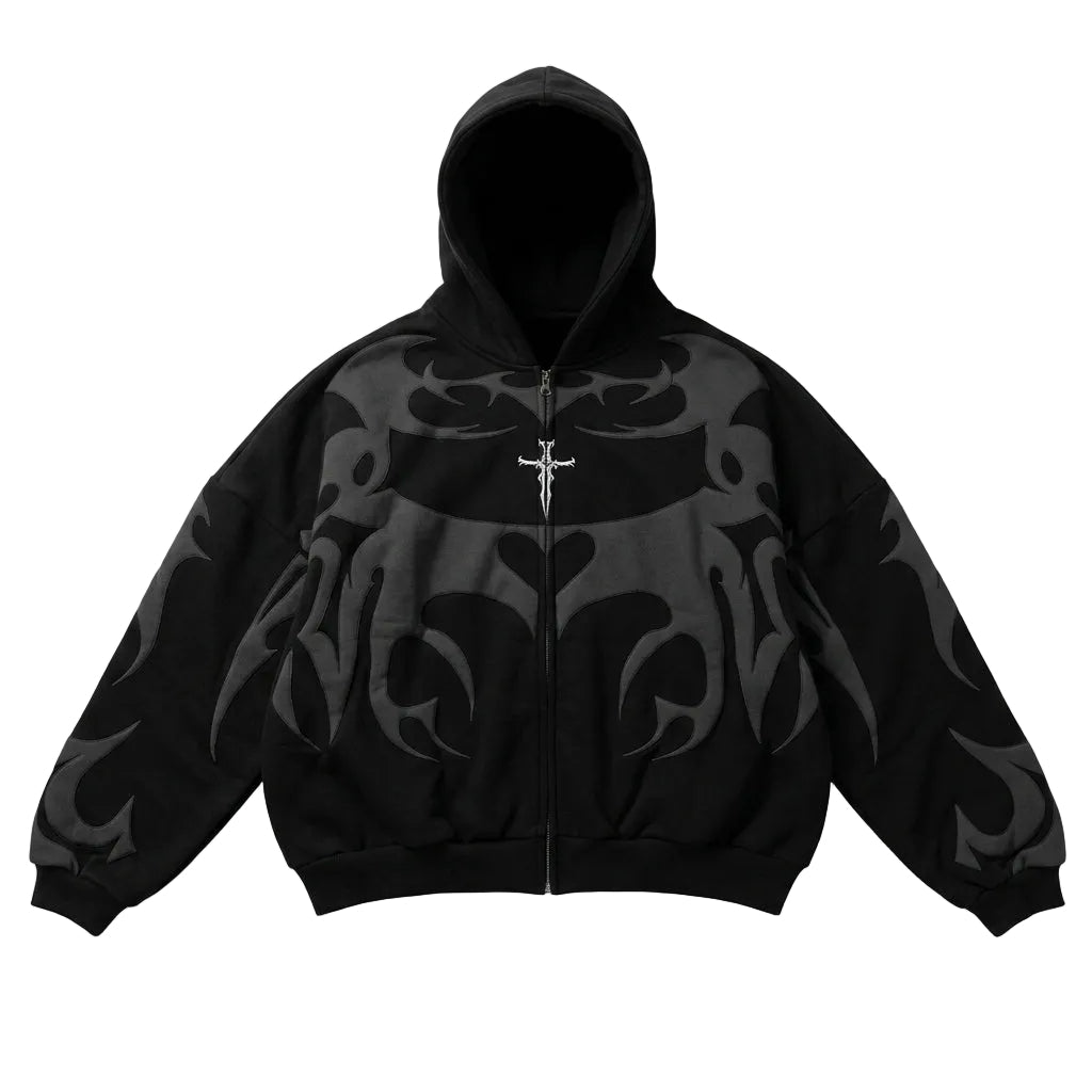 Oversized black full-zip hoodie with dark grey tribal graphics and a silver cross embroidery for a Y2K streetwear style.