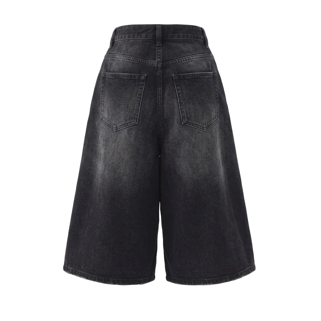 Back view of baggy washed black denim shorts with a wide-leg silhouette, back pockets, and relaxed Y2K streetwear fit.