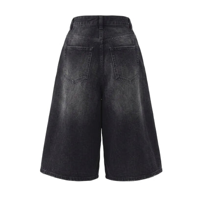 Back view of baggy washed black denim shorts with a wide-leg silhouette, back pockets, and relaxed Y2K streetwear fit.