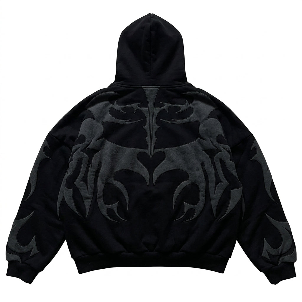 Back view of an oversized black full-zip hoodie with dark grey tribal graphic patterns for a Y2K streetwear style.