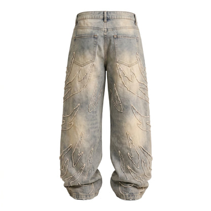 Back view of baggy light wash denim jeans featuring flame patch details and a wide-leg silhouette in a Y2K streetwear style.